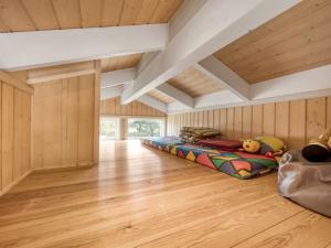 a room with two beds in a room with wooden walls at Holiday Home Asol - 650m from the sea by Interhome in Løkken