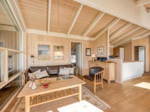 a living room with a couch and a table at Holiday Home Asol - 650m from the sea by Interhome in Løkken