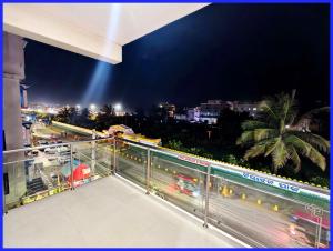 a balcony with a view of a city at night at Rooftop Sea View Boutique Shivangi Hotel Near Jagannath Temple 1400m - Restaurant- Lift and Free Parking Facilities - Fully Air Conditioning Premium Rooms- Best Sea Beach Hotel In Puri in Puri