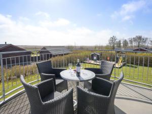 a patio with a table and chairs on a balcony at Holiday Home Benita - 400m to the fjord by Interhome in Skjern