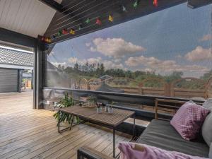 a mural on the wall of a deck with a table at Holiday Home Gizella - 500m to the inlet by Interhome in Spottrup