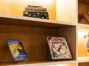 a shelf with books and a toy bus on it at Mercure Président Biarritz Plage in Biarritz