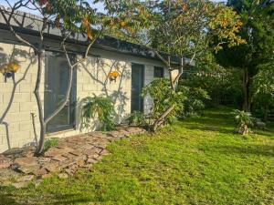 a house with a stone walkway next to a yard at Holiday Home Alica - 200m from the sea by Interhome in Neksø