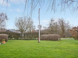 a light pole in the middle of a green field at Holiday Home Kjartan - 32m to the fjord by Interhome in Hemmet