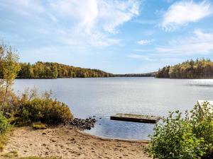 a dock on the shore of a large lake at Holiday Home Skjutsmåla by Interhome in Olofström