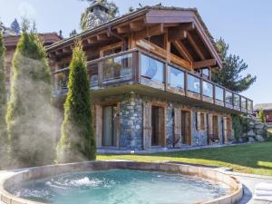 a house with a hot tub in front of it at Chalet Chalet Gerritsen by Interhome in Nendaz