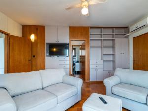 a living room with a couch and a tv at Holiday Home Robert by Interhome in Trogir