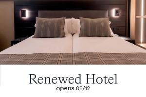 a bedroom with a large white bed with two pillows at Hotel Màgic Pas by Nexta in Pas de la Casa