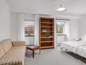 Un dormitorio con una cama y una estantería. en Holiday Home Eva - 9km to the fjord by Interhome, en Brovst