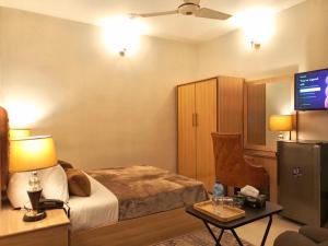 Ένα ή περισσότερα κρεβάτια σε δωμάτιο στο Grand Peace H I