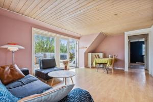 a living room with a couch and a table at Entire Apartment with 2 Bedrooms and Private Patio in Dragør +24 photos