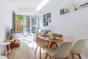 a white living room with a table and chairs at Residencias Bernabéu in Madrid