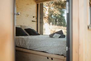 a bed in a room with a mirror at Refuge panoramique en Haute-Loire in Saint-Julien-Molhesabate