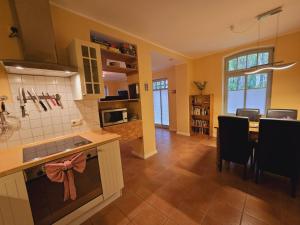 a kitchen and dining room with a table and chairs at Haus am Meer Whg3 in Rerik +16 photos