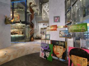 a room with a staircase and posters on the wall at Pullman Jakarta Central Park in Jakarta +177 photos