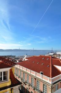 a view of the roofs of buildings in a city at Martinhal Lisbon Chiado in Lisbon