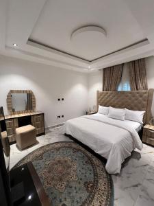 a bedroom with a large bed and a mirror at Diligent Homes in Abuja