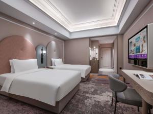 a hotel room with two beds and a desk at Mercure Beijing Downtown in Beijing +82 photos