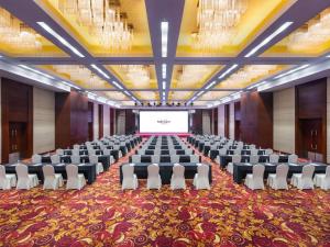 a large room with chairs and a projection screen at Mercure Beijing Downtown in Beijing +86 photos