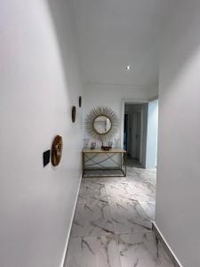 a hallway with a mirror and a marble floor at Diligent Homes in Abuja