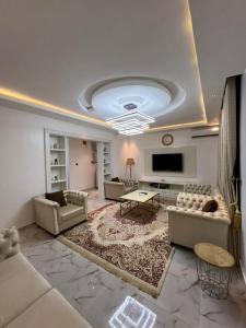 a large living room with couches and a tv at Diligent Homes in Abuja
