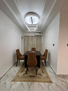 a dining room with a table and chairs at Diligent Homes in Abuja