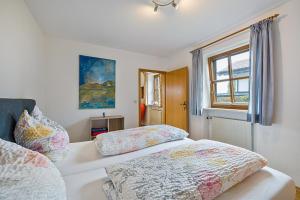 a bedroom with two beds and a window at Landhaus Kauderer - Wohnung 1 in Waging am See
