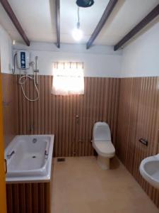 a bathroom with a toilet and a sink at Argyle Rock Bungalow in Hatton