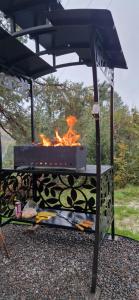a grill with a fire inside of it at Nice House in Maidan Village