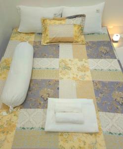 a bed with a white pillow on top of it at Hang Camping 2 in An Ninh