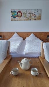 a bedroom with a bed with two tea pots on the floor at Centre Thermal - Studio SUD terrasse in Ovronnaz
