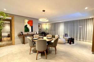 a living room with a table and chairs and a couch at State of Peace in Marina - By AppartAli in Casablanca-Port