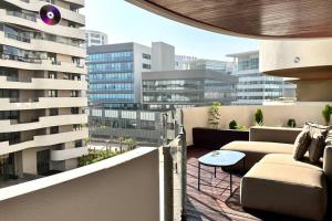 a balcony with couches and a table on a building at State of Peace in Marina - By AppartAli in Casablanca-Port