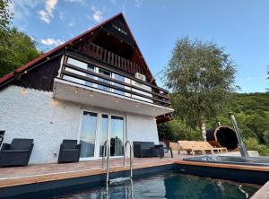 a house with a swimming pool in front of it at Willa Widokowa - balia, sauna, basen, bilard in Międzybrodzie Bialskie