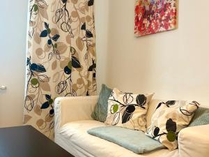 a couch with pillows on it in a living room at Urban stay Bratislava City in Bratislava