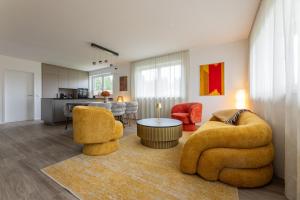 a living room with two chairs and a table at Lorenzhaus Exclusive Residence in Sankt Lorenz