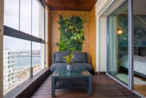 a room with a couch and a table on a balcony at La Terrazza at Marina - By AppartAli in Casablanca-Port