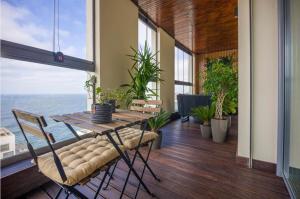 a dining room with a table and a view of the ocean at La Terrazza at Marina - By AppartAli in Casablanca-Port