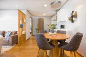 a kitchen and dining room with a table and chairs at La Terrazza at Marina - By AppartAli in Casablanca-Port +15 photos