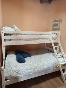 a white bunk bed with a blue stuffed animal on it at Casa rural TIO PEDRITO in Robledillo