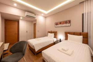 a hotel room with two beds and a chair at Lanna Fusion in Hang Dong +62 photos