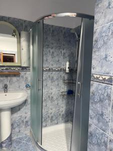a bathroom with a shower and a sink at Ermal's House in Fier