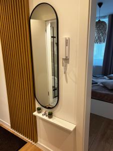a mirror on a wall next to a room at Apartament na Moniuszki in Cieszyn +26 photos