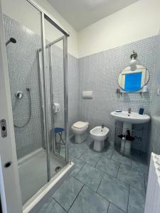 a bathroom with a shower and a toilet and a sink at La Maison di Bea in Manfredonia +34 photos