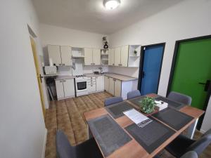 a kitchen with a table and chairs in a room at Hotel Squash House in Prievidza
