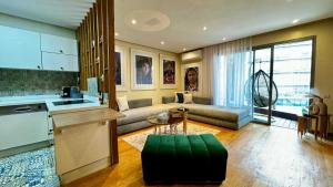 a kitchen and living room with a couch and a table at Marina Chalet Ocean View - By AppartAli in Casablanca-Port
