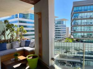 a balcony with a couch and a view of a building at Marina Chalet Ocean View - By AppartAli in Casablanca-Port