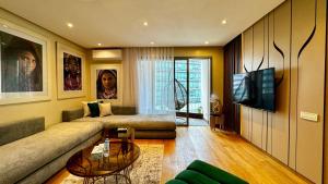 a living room with a couch and a tv at Marina Chalet Ocean View - By AppartAli in Casablanca-Port +33 photos