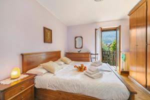 a bedroom with a large bed with towels on it at Maison Rosamunda - Happy Rentals in Oulx