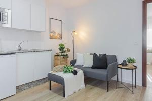 a living room with a couch and a chair at Terreo 10-12 in A Coruña +35 photos
